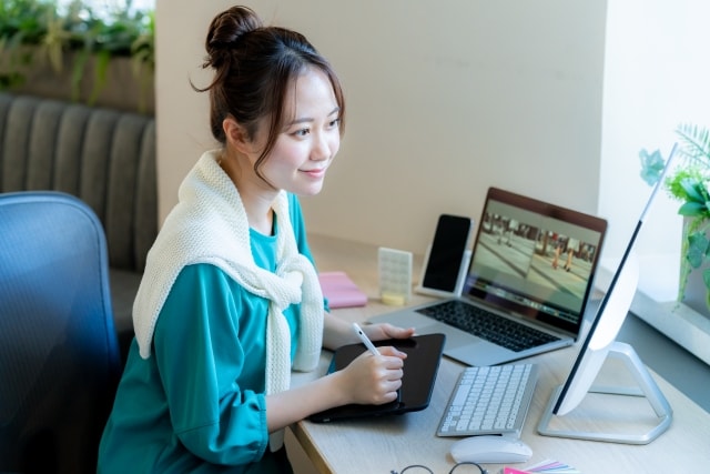 A woman working on a computer in a modern office