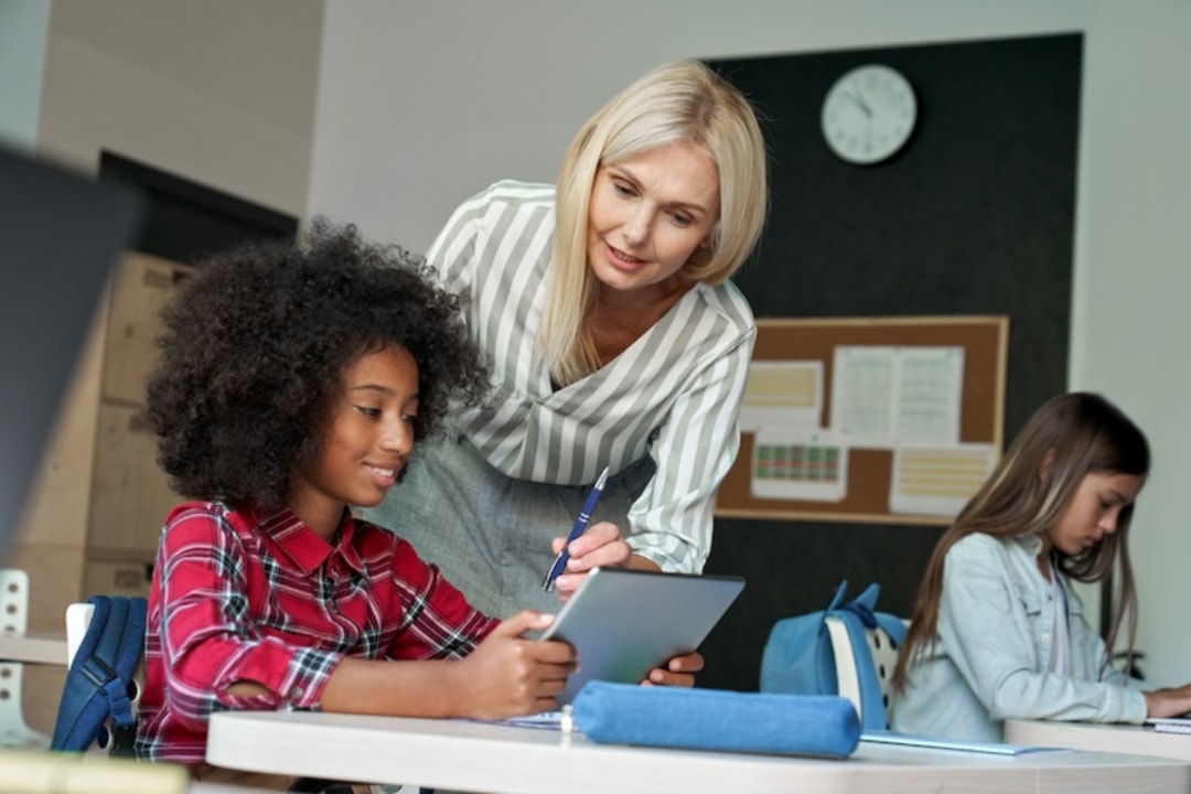 female teacher talking with female student