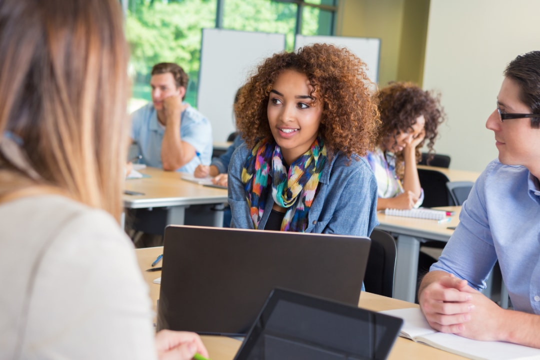 female with male student at desk